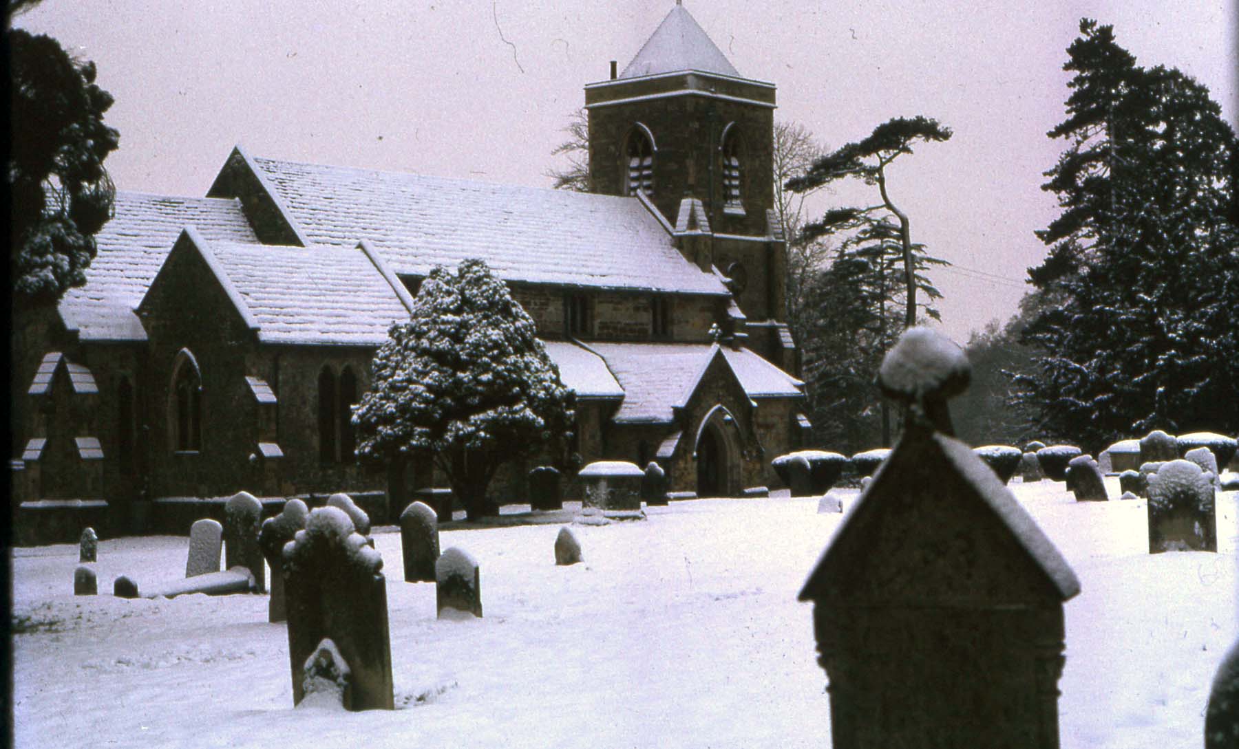 Snow rests on the church roof and churchyard