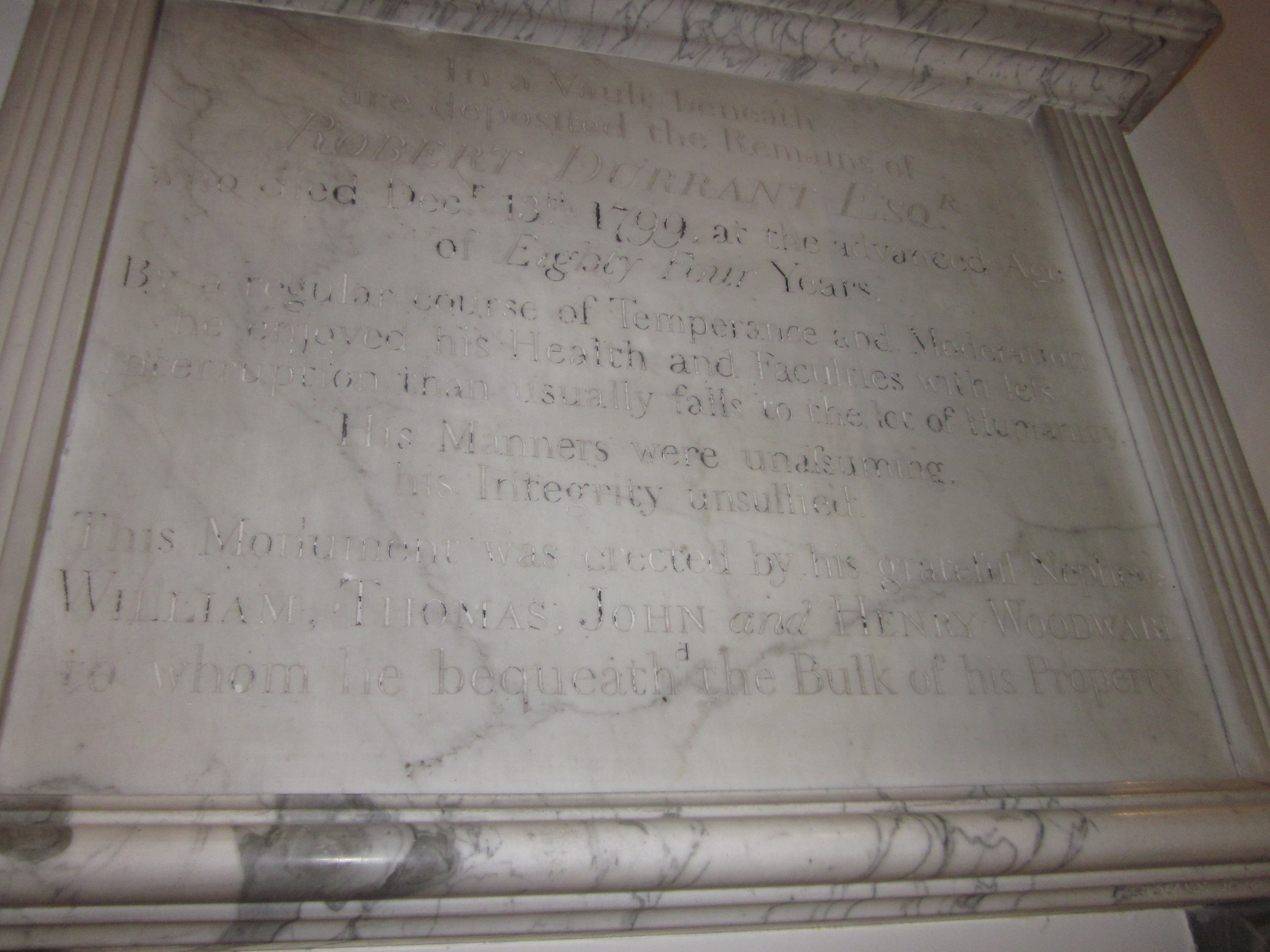 In a vault beneath are deposited the Remains of Robert Durrant, Esq., who died December 13th, 1799, at the advanced age of 84 years. By a regular course of temperance and moderation, he enjoyed his health and faculties with less interruption than usually falls to the lot of humanity.
His manners were unassuming ; his integrity unsullied. This monument was erected by his grateful nephews William, Thomas, John, and Henry Woodward, to whom he bequeathed the bulk of his property.